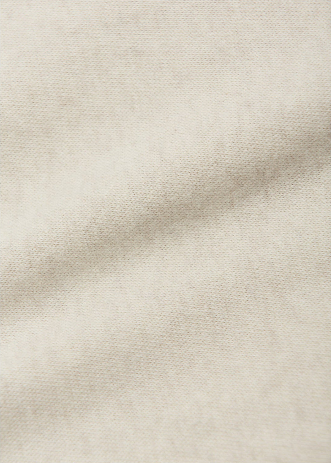 A close-up of the light beige Baby Enes Brushed Knit Leggings by Arsene & Les Pipelettes shows the textured weave and a soft diagonal fold, highlighting their ideal fabric quality for babies.