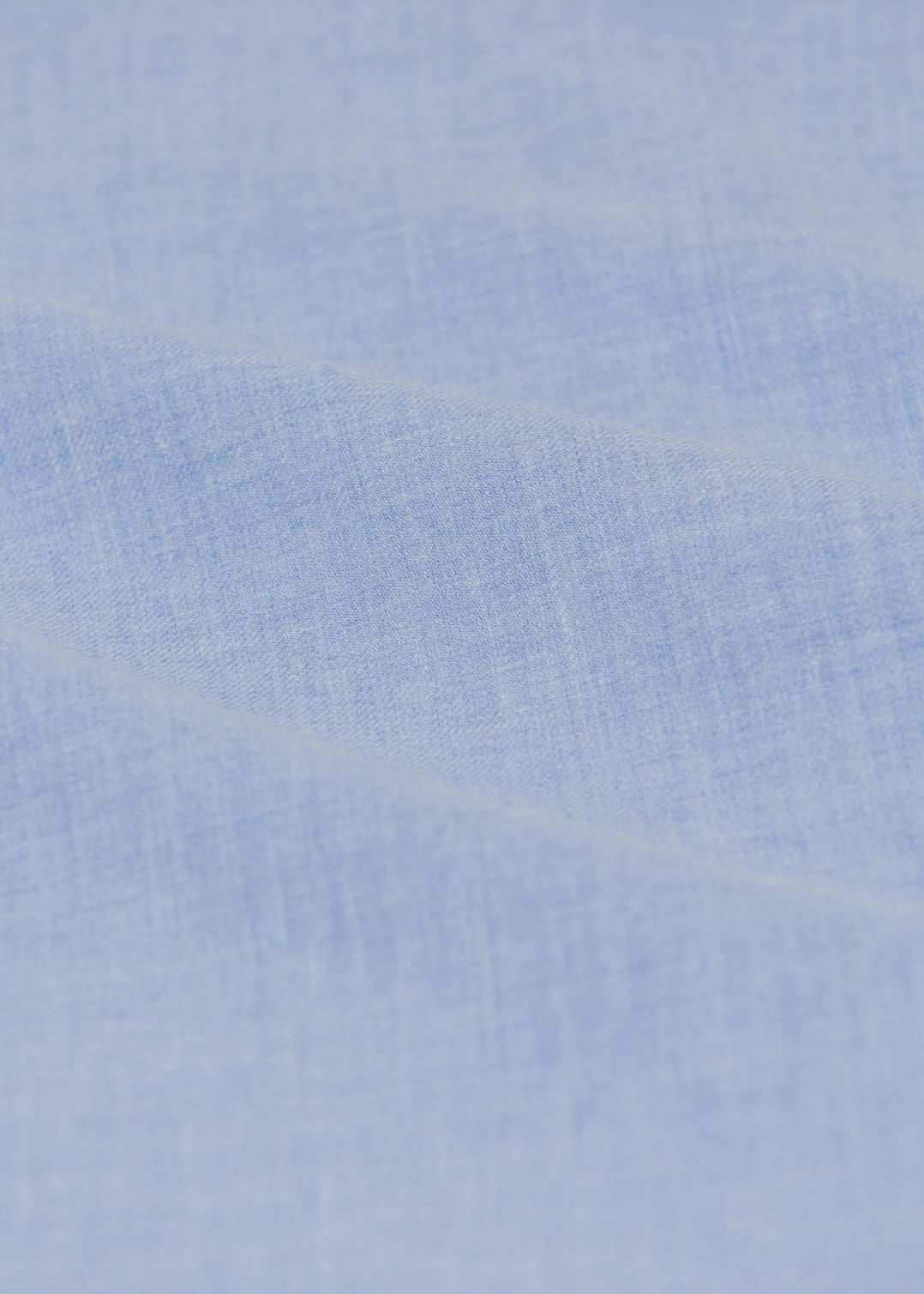 Close-up of the Baby Girls' Giovana Dress by Arsene & Les Pipelettes, featuring soft light blue fabric with a gentle texture and subtle diagonal folds—ideal for a delicate baby dress.