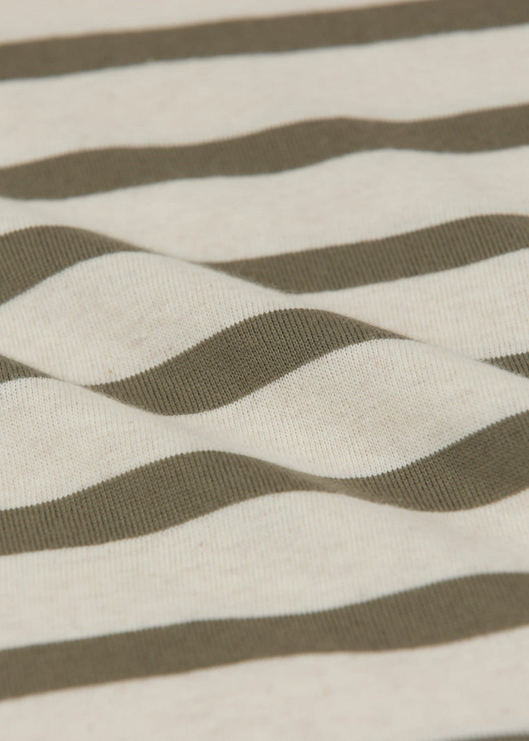Close-up of the Baby Boys' Charly Striped Shirt by Arsene & Les Pipelettes, showing its horizontal olive green and off-white stripes with a gentle wave—ideal for a classic baby sailor look.