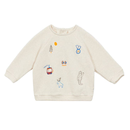 The Arsene & Les Pipelettes Baby Gideon Embroidery Sweatshirt in beige features assorted embroidered patches—a tree, sun, cable car, deer, skis, medal, and Bigfoot—on the front.
