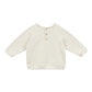 The Arsene & Les Pipelettes Baby Gideon Embroidery Sweatshirt is a cream-colored, long-sleeved toddler pullover with a round neck and three front buttons.
