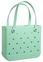 A durable green Baby Bogg Bag tote with holes.