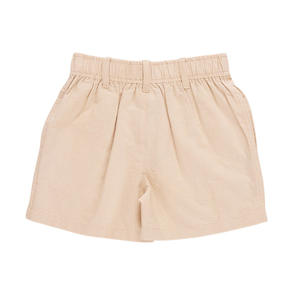 The Pink Chicken Baby Boys’ Jackson Short in beige features a high-waisted cotton canvas design with a pull-on elastic waist and belt loops, shown flat on a white background.