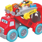 The Maisto My 1st Collection Racing Transporter is a vibrant red toy truck with playful cartoon eyes, carrying a yellow Lamborghini Huracán race car and colorful blocks decorated with trophies and numbers.