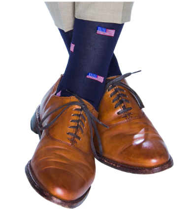 Pair brown leather shoes with gray pants and Dapper Classics American Flag Mid Calf Socks, which are crafted from breathable mercerized cotton for a comfortable wear.