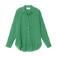 The Xirena Beau Shirt is a green, long-sleeve button-up made from lightweight cotton poplin with a collar, shown against a white background.