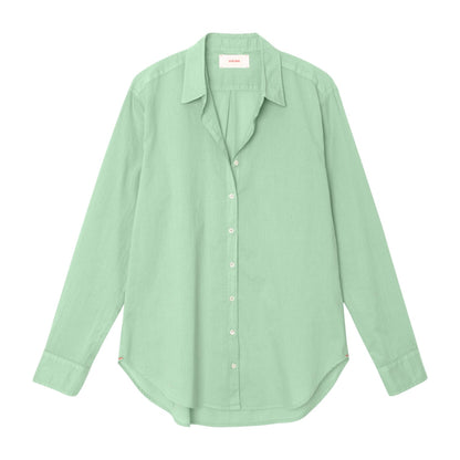 The Xirena Beau Shirt is a light green, long-sleeve boyfriend shirt made from soft cotton poplin, shown laid flat on a white background.