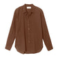 The Xirena Beau Shirt is a brown, long-sleeve button-up with a collar, made from lightweight cotton poplin and shown flat on a white background.