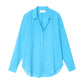 The Xirena Beau Shirt, a relaxed-fit, long-sleeve button-up in bright blue lightweight cotton poplin with a collar, is laid flat against a white background.