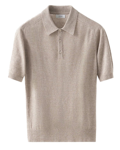 The Eton Beige Cotton Linen Polo features a collar, three buttons, ribbed hems, and comfortable raglan sleeves, crafted from a linen-cotton blend and shown on a plain white background.