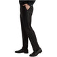 A person wearing the Samuelsohn Bennet Black Honeyway Contemporary Fit Tuxedo, styled with a black shirt and black loafers, stands with one hand in their pocket.