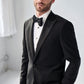 A man in a Samuelsohn Bennet Contemporary Fit Tuxedo with a bow tie posing confidently in a bright room.