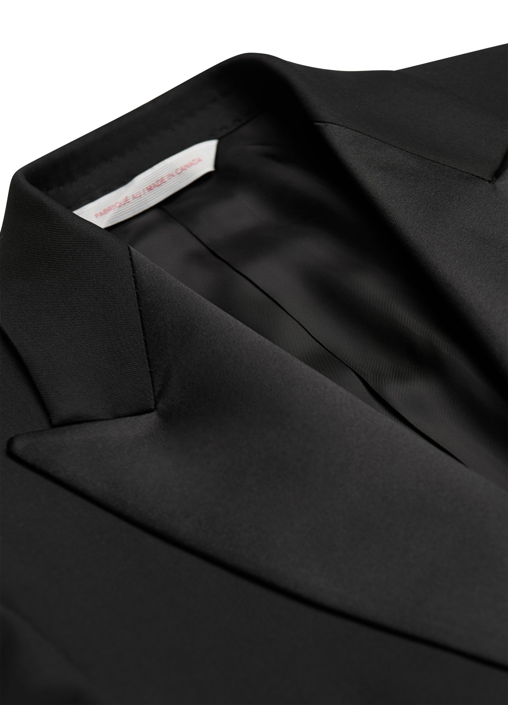 Close-up view of a black Samuelsohn Bennet Contemporary Fit Tuxedo featuring Samuelsohn craftsmanship with a visible brand label inside the collar.