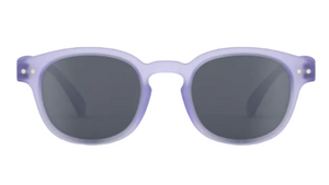 A pair of IZIPIZI Kids’ #C Polarized Sunglasses featuring an ergonomic design, round dark lenses, and a translucent light purple frame, displayed against a white background.