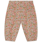 Introducing the Serendipity Baby Light Woven Pants: loose-fitting, baggy baby pants with an elastic waistband and cuffs, showcasing a charming all-over floral pattern in pink, green, and orange tones. Crafted from GOTS certified organic cotton, these pants offer a soft and sustainable choice for your little one.