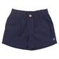The Boys’ Jackson Short by Pink Chicken features navy blue cotton canvas, an elastic waistband, button closure, belt loops, and a small embroidered rooster on the left leg.