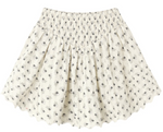 The Girls’ Smocked V Mini Skirt by Rylee & Cru features a smocked waistband, scalloped hem, and a delicate small black floral print on lightweight fabric. This timeless silhouette effortlessly blends comfort and style for an elegant look.
