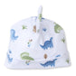 The Kissy Kissy Baby Dinosaur Novelty Hat is a soft white Pima cotton hat with a playful top knot, decorated with blue and green dinosaurs and leafy plants.
