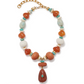 The Andamento Necklace by Lizzie Fortunato features multicolored beads in orange, white, turquoise, and gold with a bold central pendant and an adjustable gold chain—perfect for elevating any outfit.