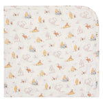 The Magnetic Me Moments With Friends Baby Blanket features a soft white fabric decorated with pastel Winnie the Pooh patterns—an adorable, cozy addition to any nursery and a treasured keepsake.