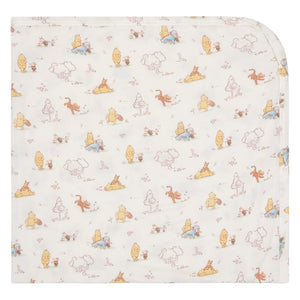 The Magnetic Me Moments With Friends Baby Blanket features a soft white fabric decorated with pastel Winnie the Pooh patterns—an adorable, cozy addition to any nursery and a treasured keepsake.