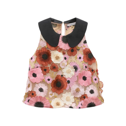 The Blooming Meadow Top by Dorothee Schumacher features a sleeveless A-line silhouette with a black Peter Pan collar and pink, red, and white 3D floral embroidery on sheer silk crêpe de chine.