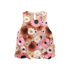The Blooming Meadow Top by Dorothee Schumacher is a sleeveless couture A-line design featuring sheer silk crêpe de chine and bold 3D floral embroidery in pink, red, white, and black.