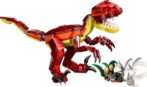 The LEGO® Creator 3-in-1 Fierce Dinosaur by Legos - Toyhouse features a red and yellow dinosaur next to a white nest with two eggs and green leaves for exciting building play.