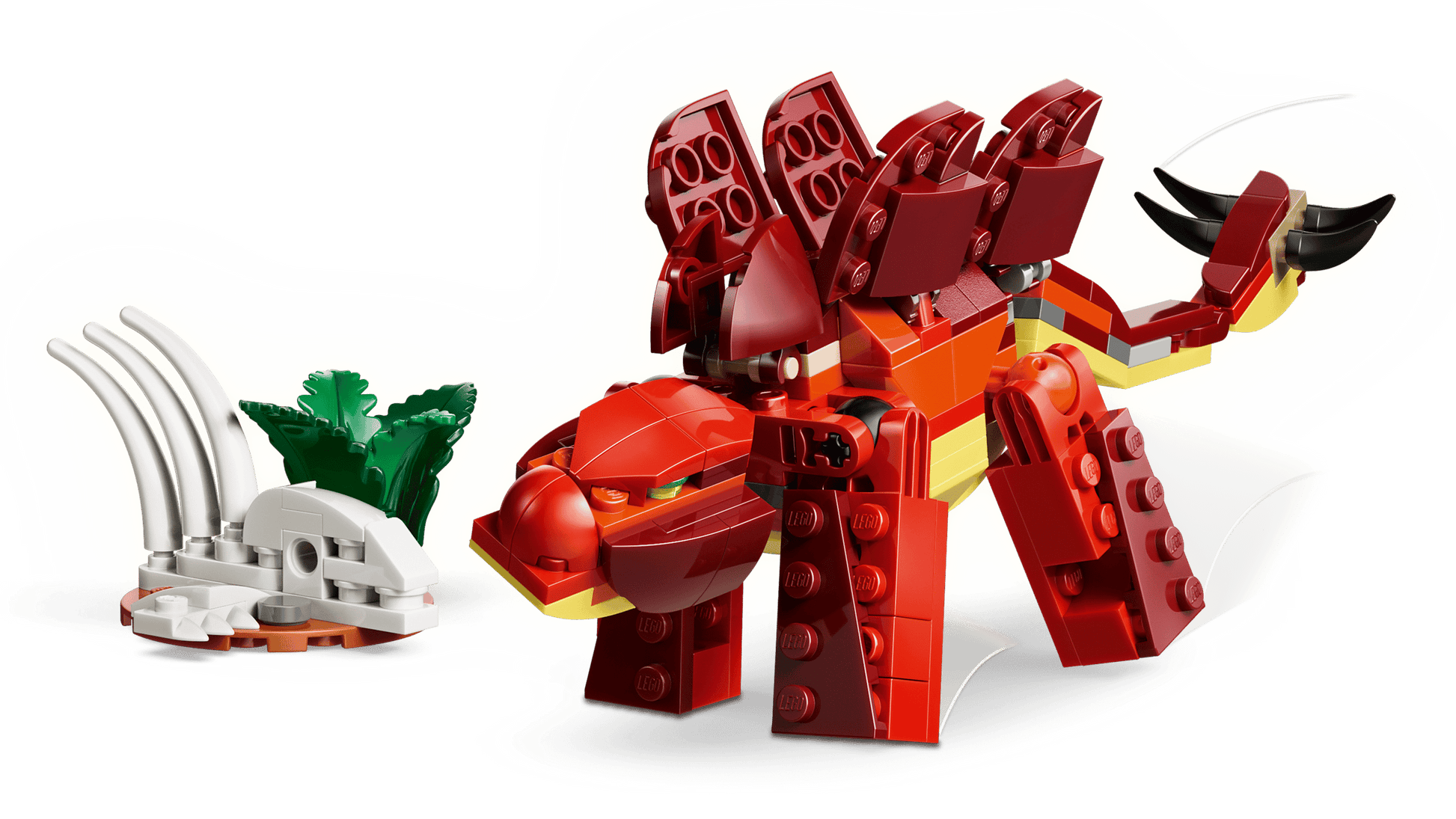 A red LEGO® stegosaurus from the Legos - Toyhouse LEGO® Creator 3-in-1 Fierce Dinosaur set stands next to a small white skeleton with green leaves.