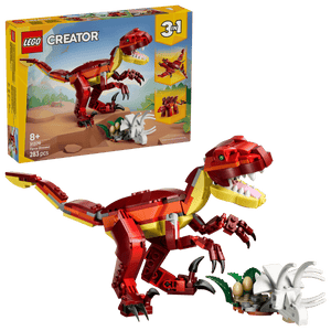 The LEGO® Creator 3-in-1 Fierce Dinosaur by Legos - Toyhouse includes a red T-Rex, dinosaur eggs, and a triceratops skull, with the packaging shown in the background.