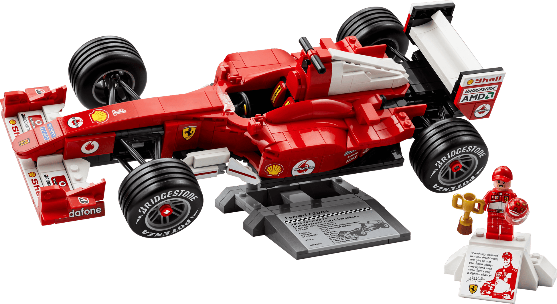 The LEGO® Icons Ferrari F2004 & Michael Schumacher by Legos - Toyhouse features a Ferrari F1 model displayed on a stand with a racing suit minifigure and a small podium with trophy.