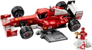 The LEGO® Icons Ferrari F2004 & Michael Schumacher by Legos - Toyhouse features a Ferrari F1 model displayed on a stand with a racing suit minifigure and a small podium with trophy.