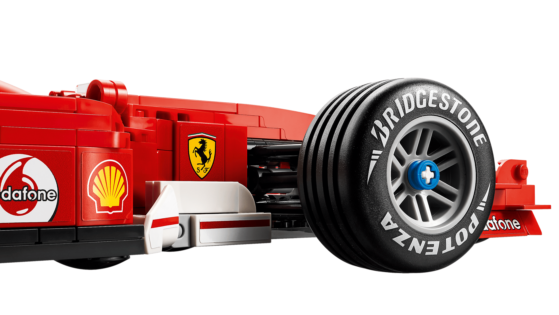 Close-up of the LEGO® Icons Ferrari F2004 & Michael Schumacher by Legos - Toyhouse, featuring the rear wheel with Bridgestone Potenza branding and sponsor logos like Vodafone and Shell.