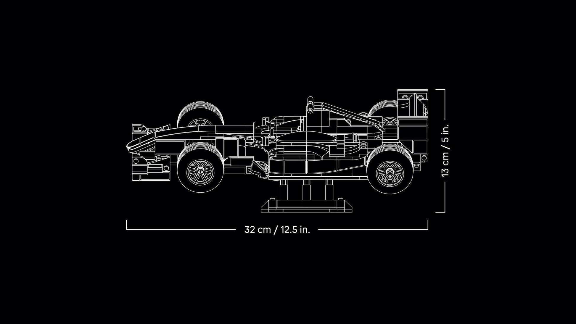 Technical line drawing of the LEGO® Icons Ferrari F2004 & Michael Schumacher by Legos - Toyhouse, side view with labeled dimensions: 32 cm (12.5 in.) long and 13 cm (5 in.) high.