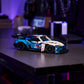 A LEGO® Technic™ BMW M4 GT3 EVO Race Car kit from Legos - Toyhouse rests on a metal desk in a dim room with electronics and computers—a great STEM building toy for fans.
