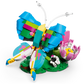 The LEGO® Creator 3-in-1 Wild Animals: Colorful Hummingbird by Legos - Toyhouse features a vibrant hummingbird with blue, yellow, pink, and green wings perched on a green base with a pink and white flower.
