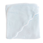 The Terry Tots Kids’ Scalloped Hooded Towel is displayed folded in light blue with a crisp white trim and a distinctive wavy edge, making it a charming essential for any nursery.