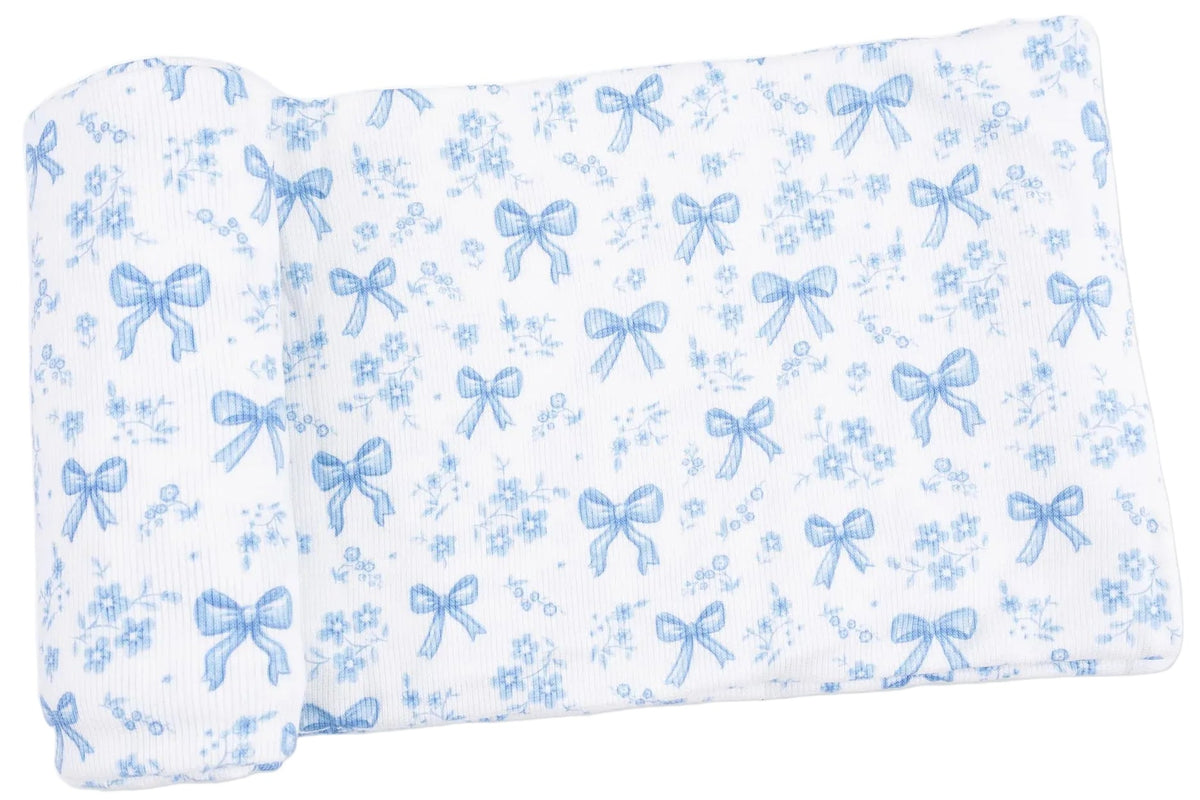 Crafted by Angel Dear, the Swaddle Blanket features white fabric adorned with light blue bows and floral patterns. Folded at one end, this soft blanket is made from lightweight Viscose from Bamboo, offering exceptional comfort for your baby.
