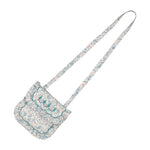 The Floral Blue Purse by Antoinette is a small, floral-patterned shoulder bag with a long strap and scalloped flap—ideal for pairing with your favorite Yse dress or completing an Antoinette-inspired outfit. Displayed on a white background.
