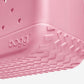 Close-up of a pink Original Bogg® Bag by Bogg Bags, showcasing its textured bottom corner with the raised “bogg” logo and distinctive grooved tread pattern. This washable bag combines style and practicality for everyday use.