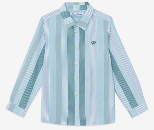 The Boys’ Badge Stripe Shirt by Tartine et Chocolat features light blue and white vertical stripes, long sleeves, a classic collar, and a small embroidered logo on the left chest. Made from soft cotton, this button-up is perfect for casual looks.