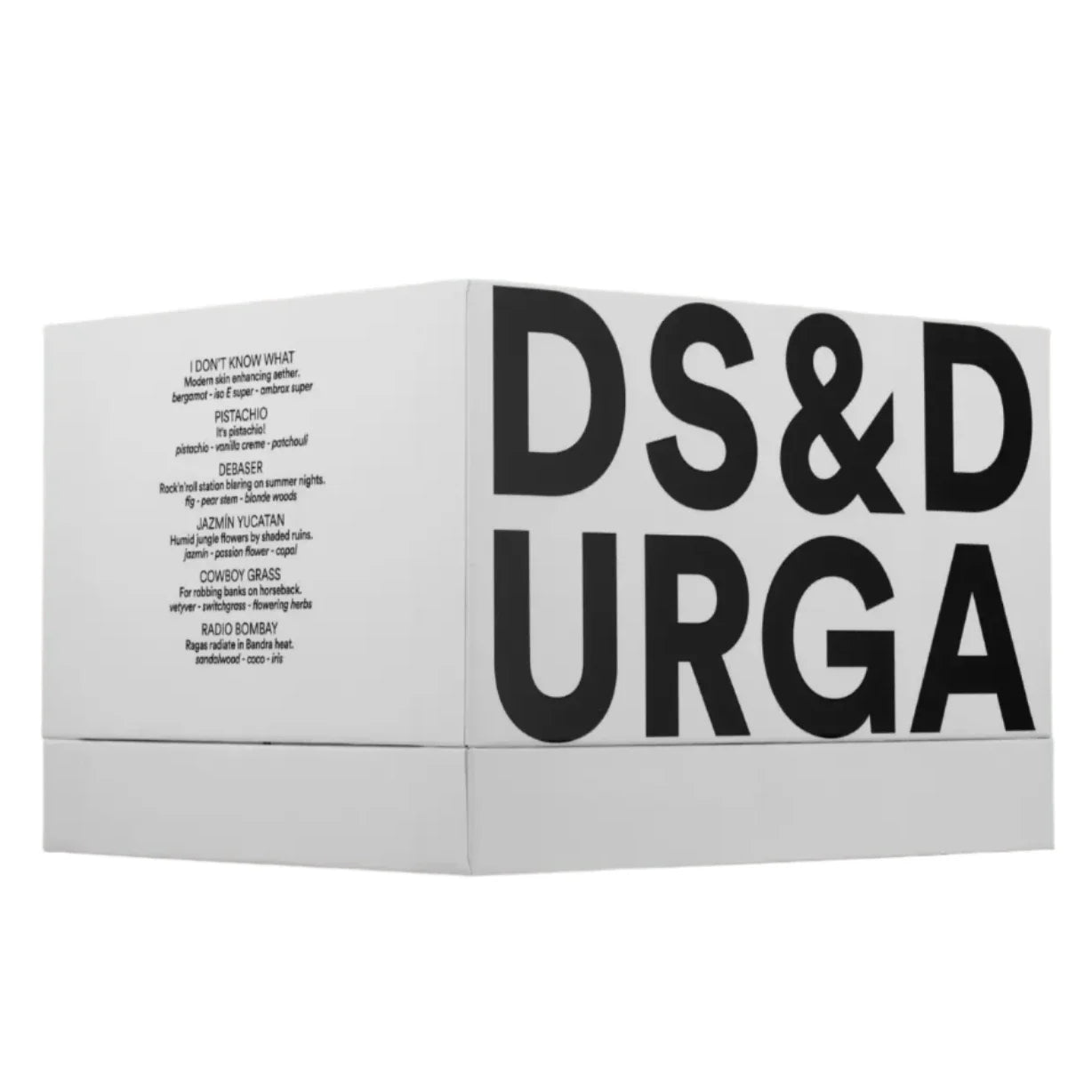 The D.S. & DURGA Deluxe Box Set is adorned with prominent black text displaying "D. S. & Durga," and includes smaller text on the side that enumerates a variety of scents, providing an experience of armchair travel through its collection of miniature perfumes.