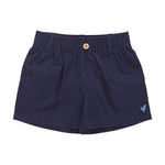 The Pink Chicken Baby Boys’ Jackson Short features navy blue cotton canvas, a comfortable pull-on elastic waistband with a front button closure, belt loops, and a small embroidered bird logo on the left leg—perfect for your little one.