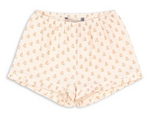 Konges Slojd Baby Girls’ and Girls’ Coco Shorts in light pink muslin, featuring a floral print, ruffled details, pleats, and an elastic waistband, displayed on a white background.