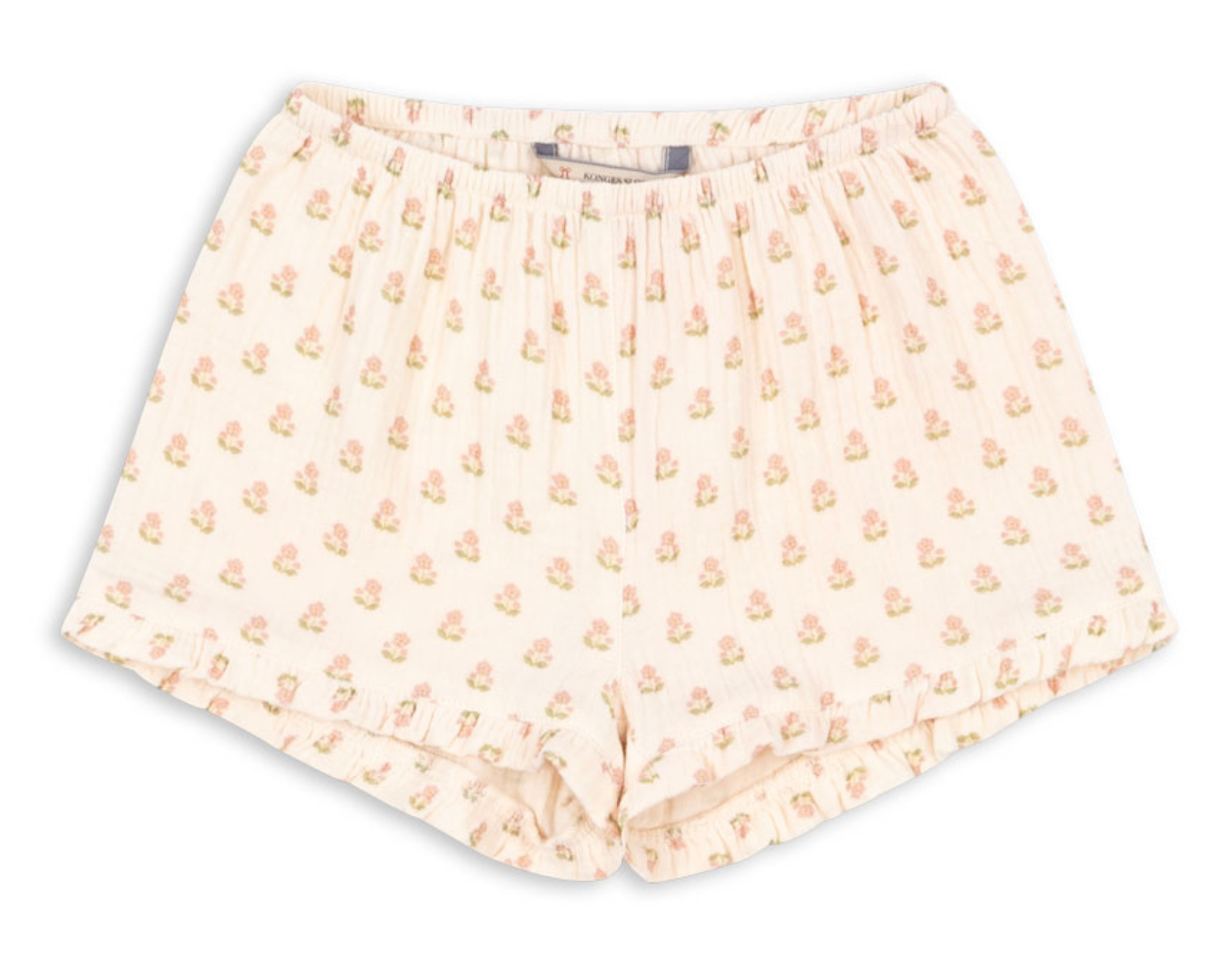 Konges Slojd Baby Girls’ and Girls’ Coco Shorts in light pink muslin, featuring a floral print, ruffled details, pleats, and an elastic waistband, displayed on a white background.