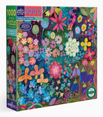 The Seeds & Flowers 1000 Piece Puzzle by Eeboo features a vibrant, illustrated floral design inspired by an early morning walk, with a variety of wild blooms.