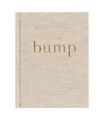 A beige fabric-covered pregnancy journal, named "Write to Me Bump A Pregnancy Story, Oatmeal" by Write To Me, features the word "bump" embossed in gold on its cover and is perfect for capturing every bump photo and weekly journal update.