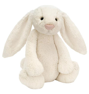 A white plush bunny with long ears, round eyes, and a pink nose sits against a plain white background. This soft bunny toy, known as Jellycat Bashful Bunny Cream, Huge by Jellycat, is the perfect cuddly companion.