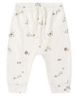 The Quincy Mae Baby and Kids’ Drawstring Pant features an elastic waistband with a drawstring, crafted from soft organic brushed jersey and adorned with delicate illustrations of rabbits, mushrooms, and flowers in muted brown and beige tones.