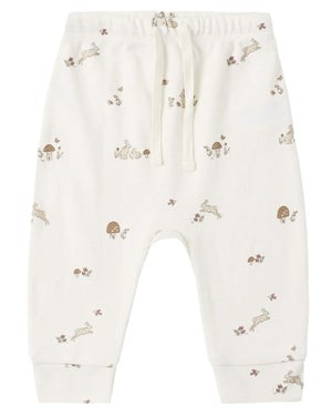 The Quincy Mae Baby and Kids’ Drawstring Pant features an elastic waistband with a drawstring, crafted from soft organic brushed jersey and adorned with delicate illustrations of rabbits, mushrooms, and flowers in muted brown and beige tones.